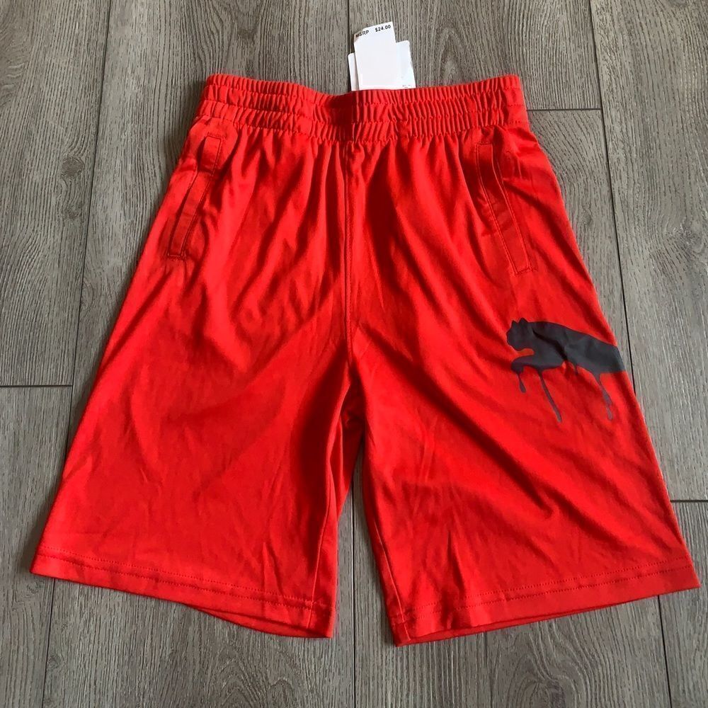 Puma boys M shorts color red with a graphic puma.